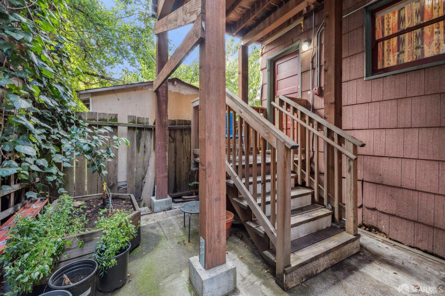 2732 Parker Street Berkeley, CA 94704 - Photo 6 of 25 a view of a house with wooden stairs and a table and potted plants