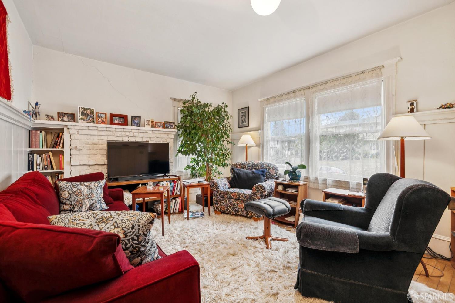 2732 Parker Street Berkeley, CA 94704 - Photo 10 of 25 a living room with furniture a flat screen tv and a large window