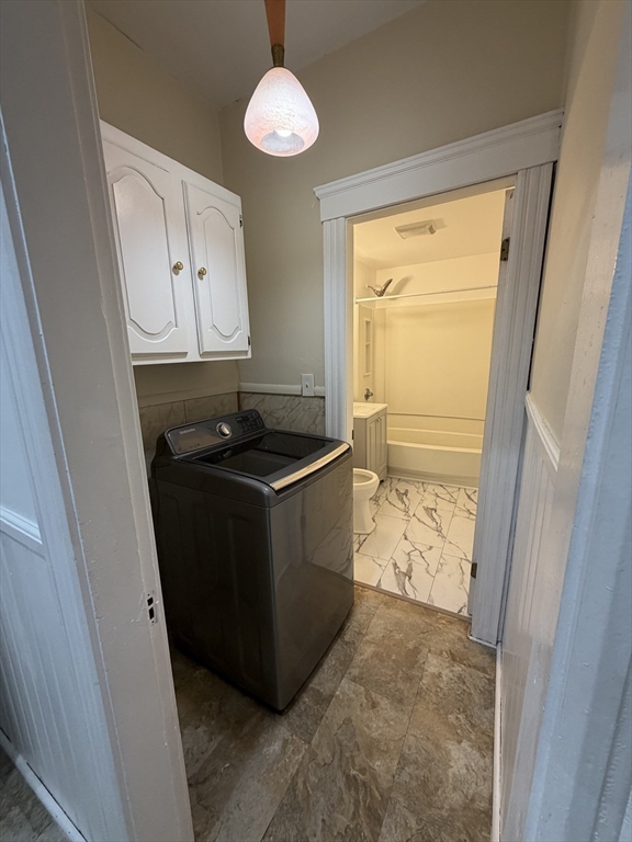 58 Tower Street, Unit 3 Worcester, MA 01606 - Photo 11 of 11 a kitchen with granite countertop cabinets and black appliances