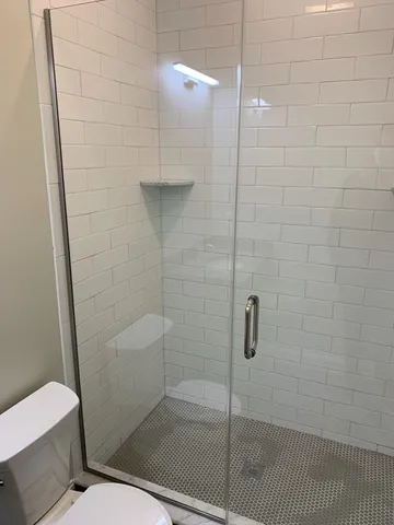 a bathroom with a shower and toilet