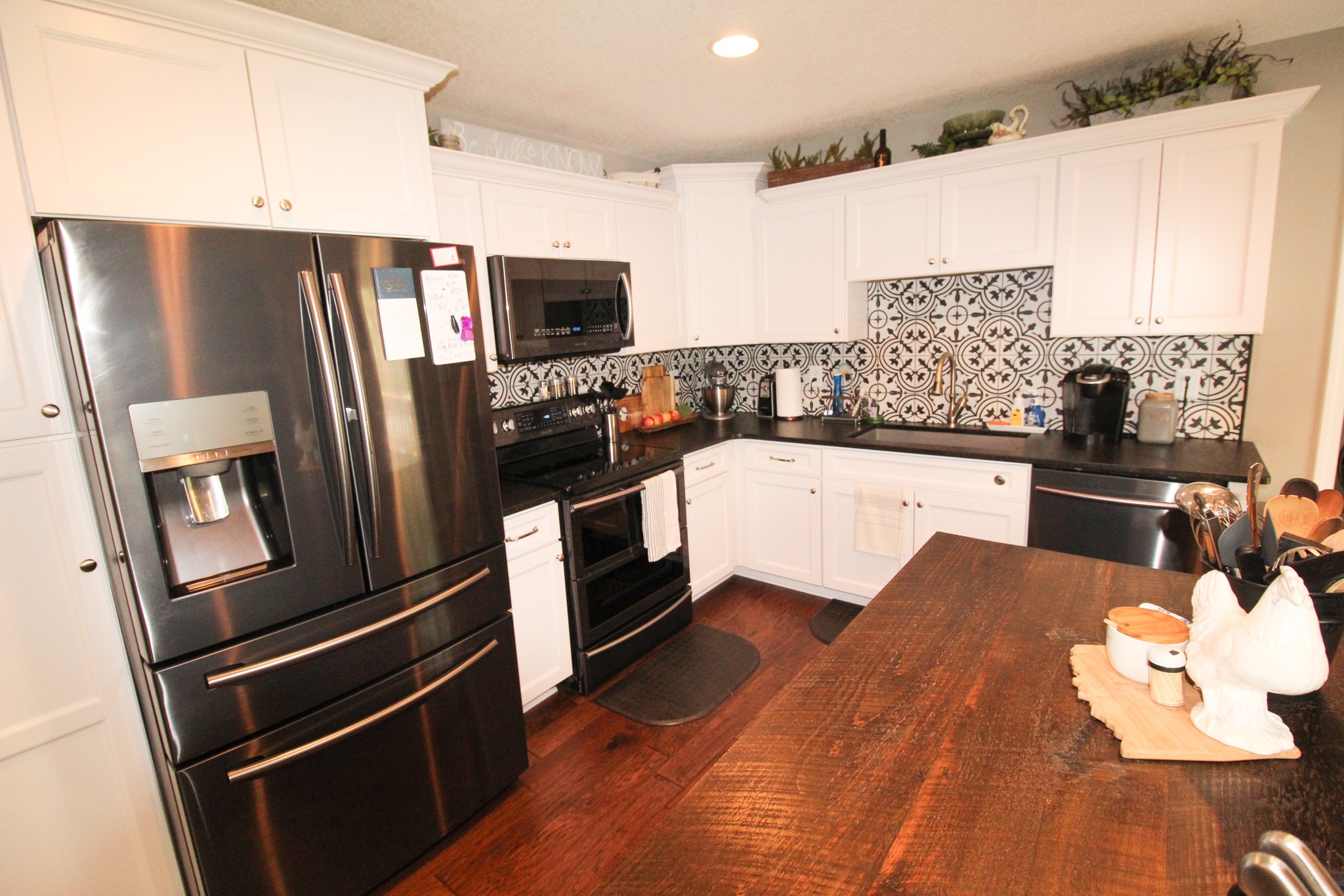 128 East Carter Road Portland, TN 37148 - Photo 7 of 26 a kitchen with stainless steel appliances a refrigerator a stove a sink and white cabinets