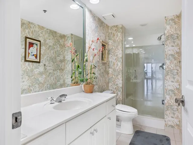 a bathroom with a sink toilet tub and shower