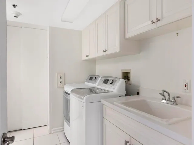 a view of a sink and washer dryer