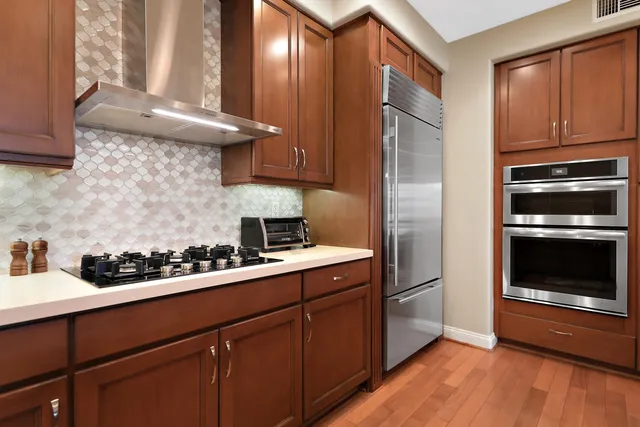 a kitchen with a refrigerator stove and sink
