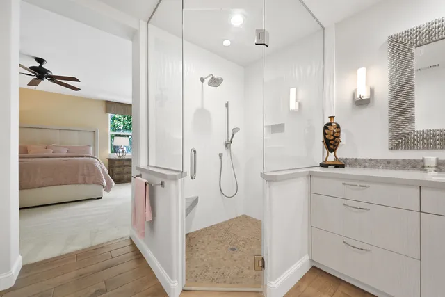 a en suite bathroom with a granite countertop sink and a mirror