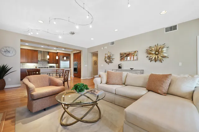 a living room with furniture kitchen view and a table