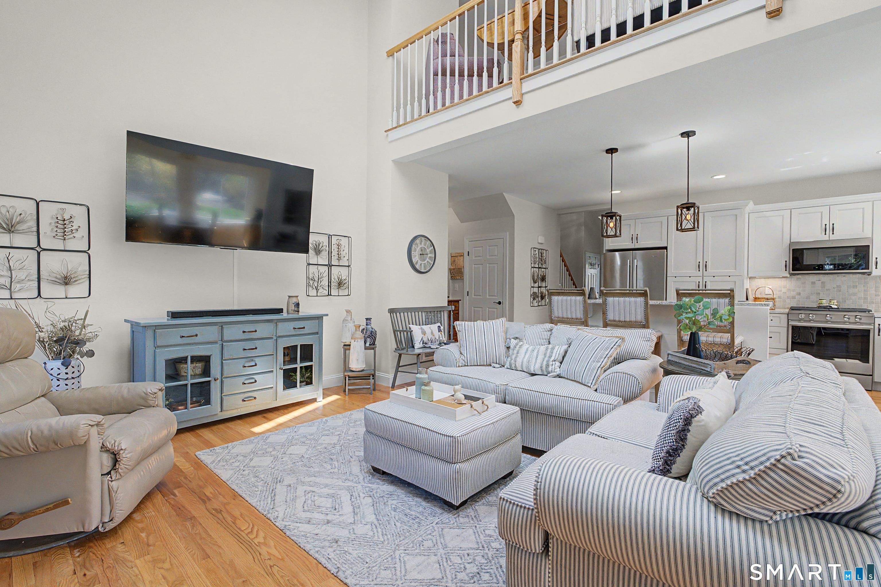 211 Meadowbrook Road, Unit 211 Oxford, CT 06478 - Photo 6 of 38 Spacious and inviting living area with loft overlook, hardwood floors, and a natural flow perfect for everyday living and entertaining.