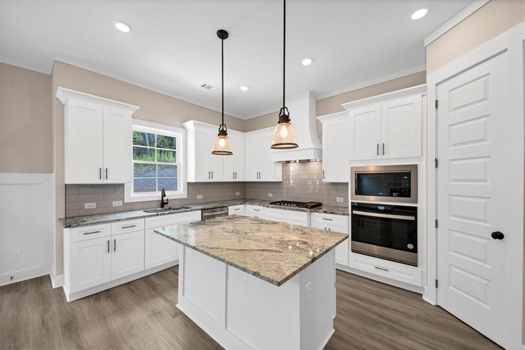 388 Oxford Road Ball Ground, GA 30107 - Photo 11 of 55 a kitchen with a sink stove and oven