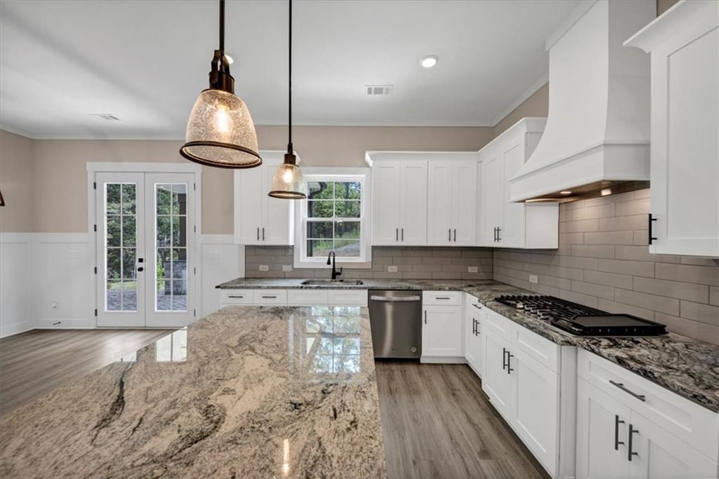 388 Oxford Road Ball Ground, GA 30107 - Photo 12 of 55 a kitchen with stainless steel appliances granite countertop a sink stove and cabinets