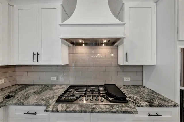a kitchen with granite countertop a sink and a window
