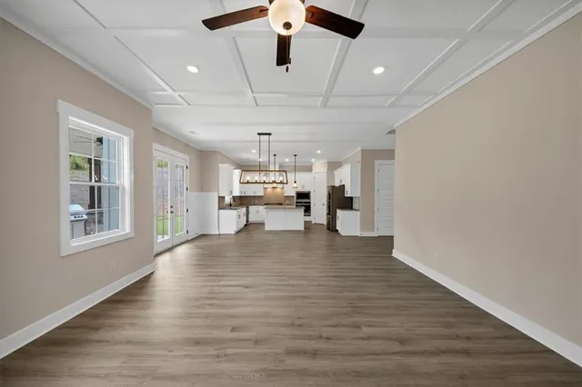 a view of a kitchen with wooden floor and windows