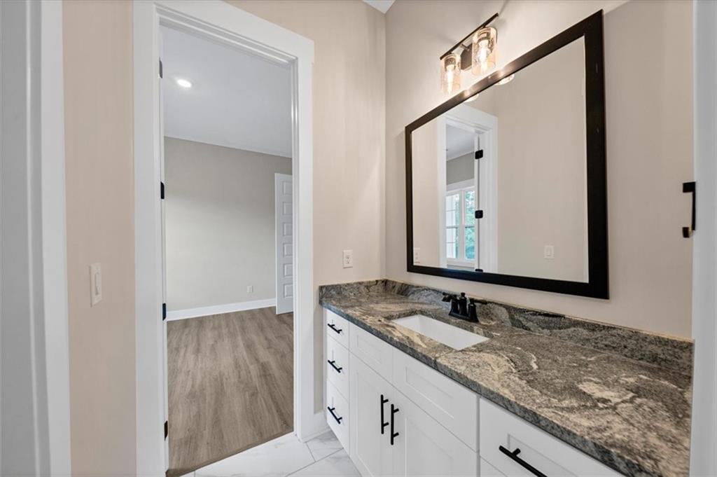 388 Oxford Road Ball Ground, GA 30107 - Photo 23 of 55 a bathroom with a granite countertop sink and a mirror