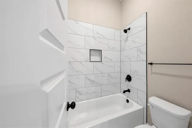 a view of a kitchen with a sink and a refrigerator