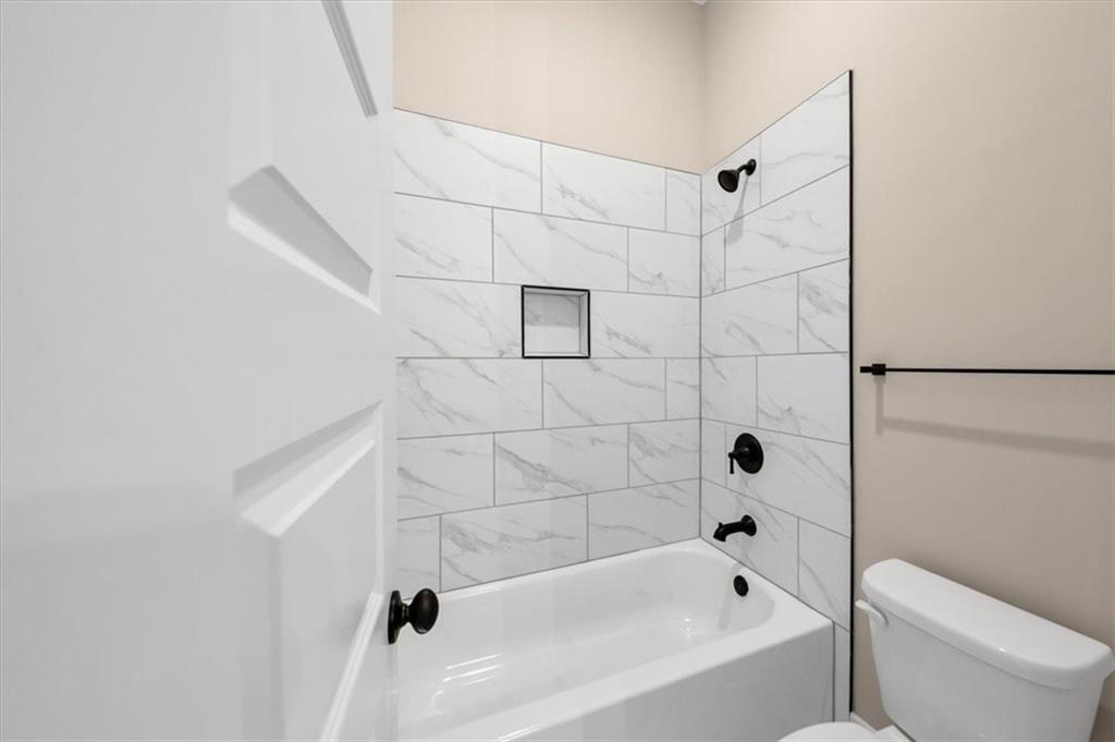 388 Oxford Road Ball Ground, GA 30107 - Photo 24 of 55 a bathroom with a bathtub and toilet