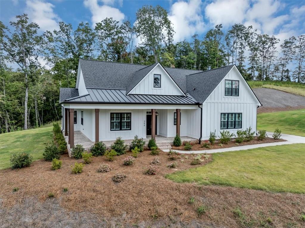388 Oxford Road Ball Ground, GA 30107 - Photo 3 of 55 a front view of house with yard and green space