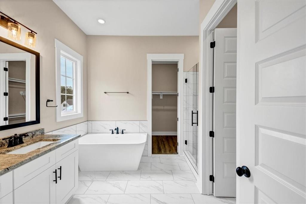 388 Oxford Road Ball Ground, GA 30107 - Photo 33 of 55 a bathroom with a double vanity sink mirror and bathtub