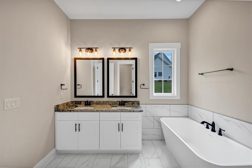 388 Oxford Road Ball Ground, GA 30107 - Photo 34 of 55 a bathroom with a sink and a bathtub