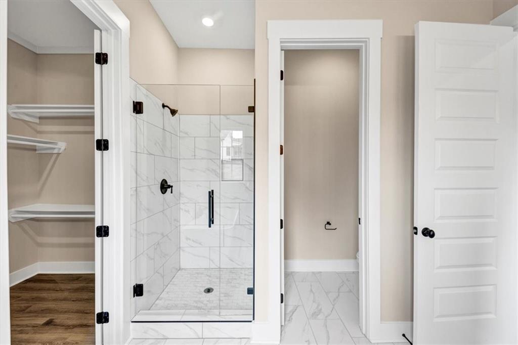 388 Oxford Road Ball Ground, GA 30107 - Photo 35 of 55 a bathroom with a glass shower door