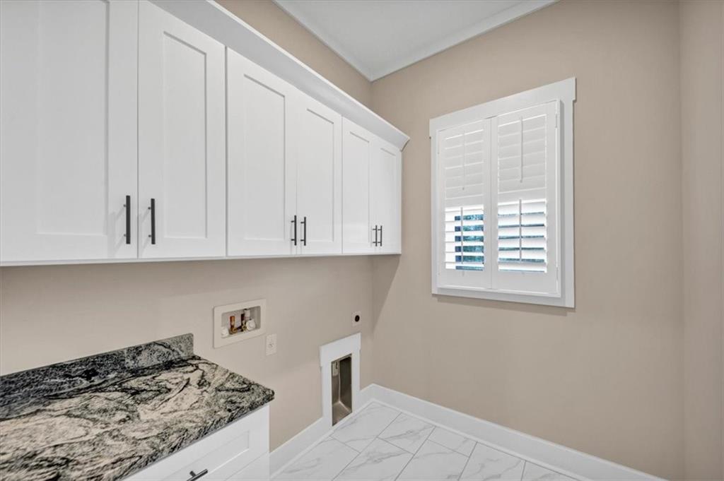 388 Oxford Road Ball Ground, GA 30107 - Photo 38 of 55 a kitchen with granite countertop white cabinets and a stove