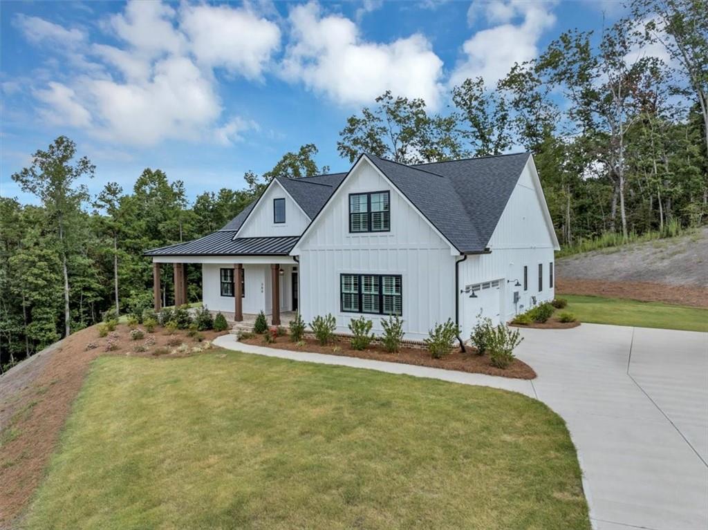 388 Oxford Road Ball Ground, GA 30107 - Photo 4 of 55 a front view of house with yard outdoor seating and entertaining space
