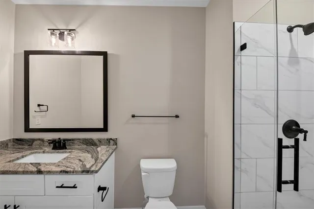 a view of a white house next to a yard with big trees