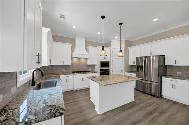 a kitchen with a sink stove and oven