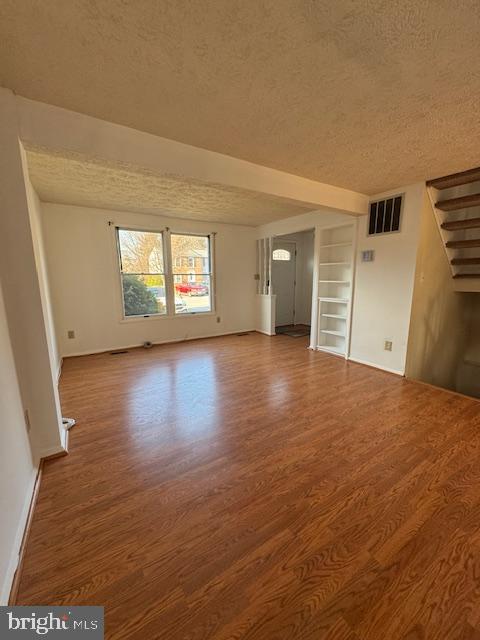 3621 Seaford Court Pasadena, MD 21122 - Photo 3 of 25 an empty room with wooden floor and windows
