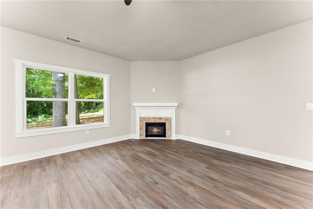 43 Anderson Street Jefferson, GA 30549 - Photo 16 of 45 a view of empty room with wooden floor and fireplace
