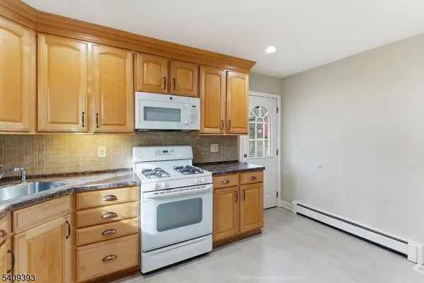 a kitchen with appliances cabinets and a sink