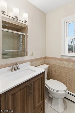 a bathroom with a sink a toilet and mirror