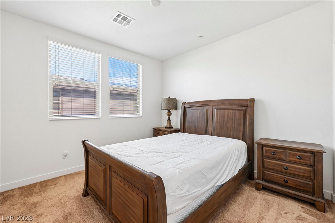 1100 East Sunset Road Henderson, NV 89011 - Photo 37 of 63 Plentiful natural light streams through multiple windows in this comfortable bedroom with soft carpeting.
