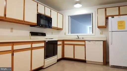 a kitchen with stainless steel appliances white cabinets and a sink