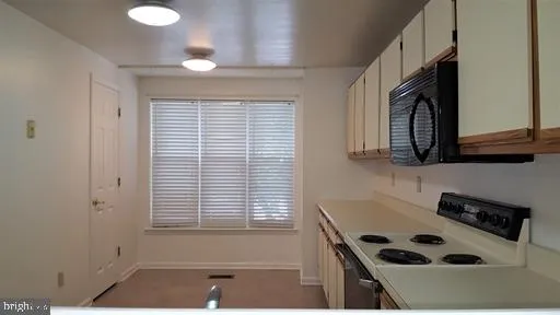 a kitchen with a window a sink and a stove