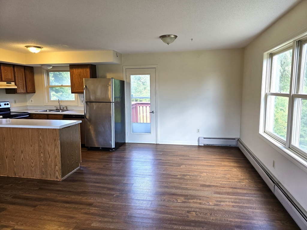 146 Old Amherst Road Sunderland, MA 01375 - Photo 5 of 16 a kitchen with stainless steel appliances a refrigerator and wooden floor