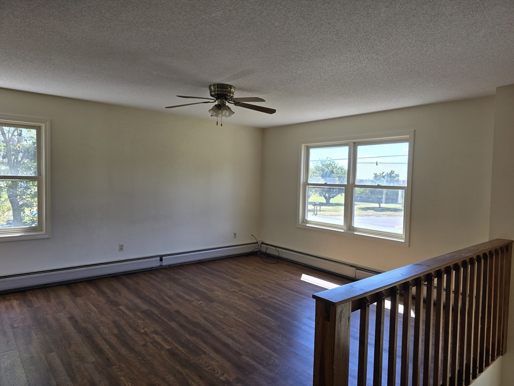 146 Old Amherst Road Sunderland, MA 01375 - Photo 7 of 16 a view of an empty room with a window and wooden floor