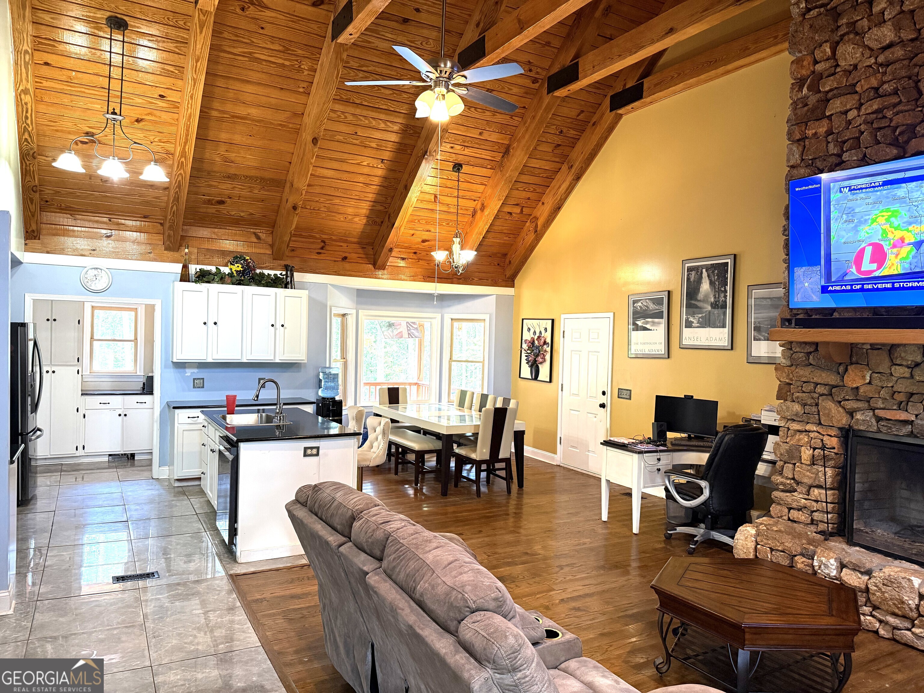 725 Musgrove Road Griffin, GA 30223 - Photo 7 of 52 a living room with fireplace furniture and a flat screen tv