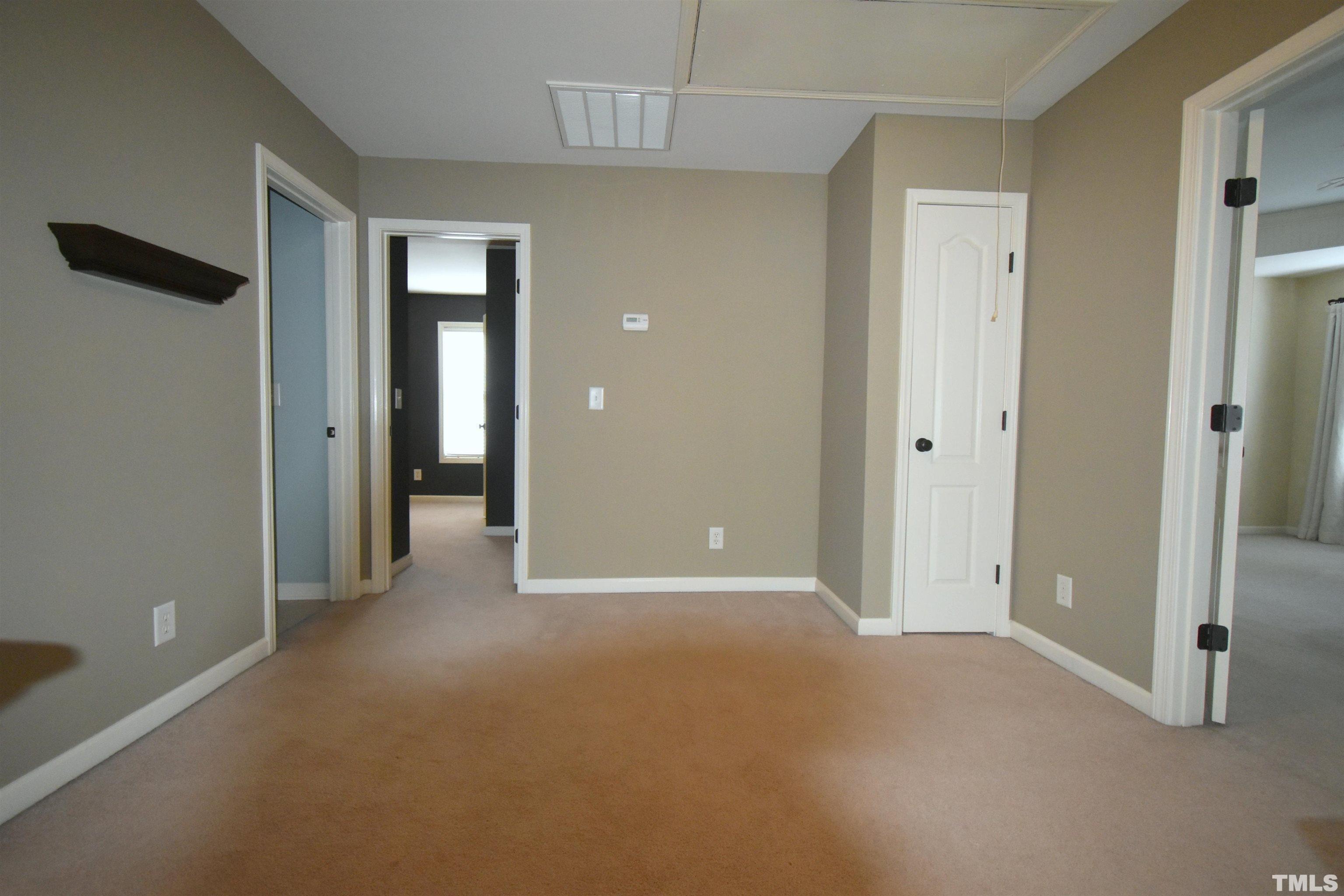 2019 Sinclair Trace Burlington, NC 27215 - Photo 18 of 32 a view of a room with an empty space and wooden floor