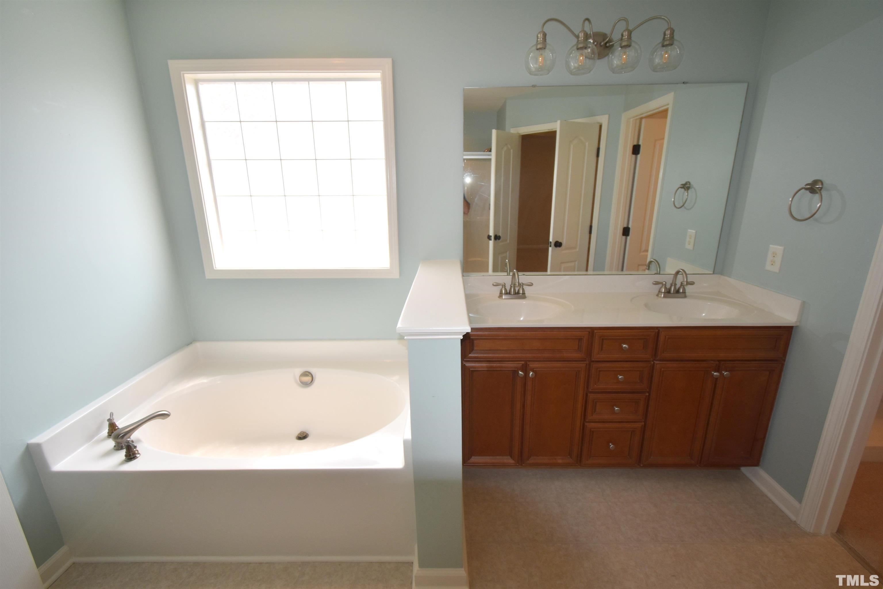 2019 Sinclair Trace Burlington, NC 27215 - Photo 20 of 32 a bathroom with a tub sink and mirror