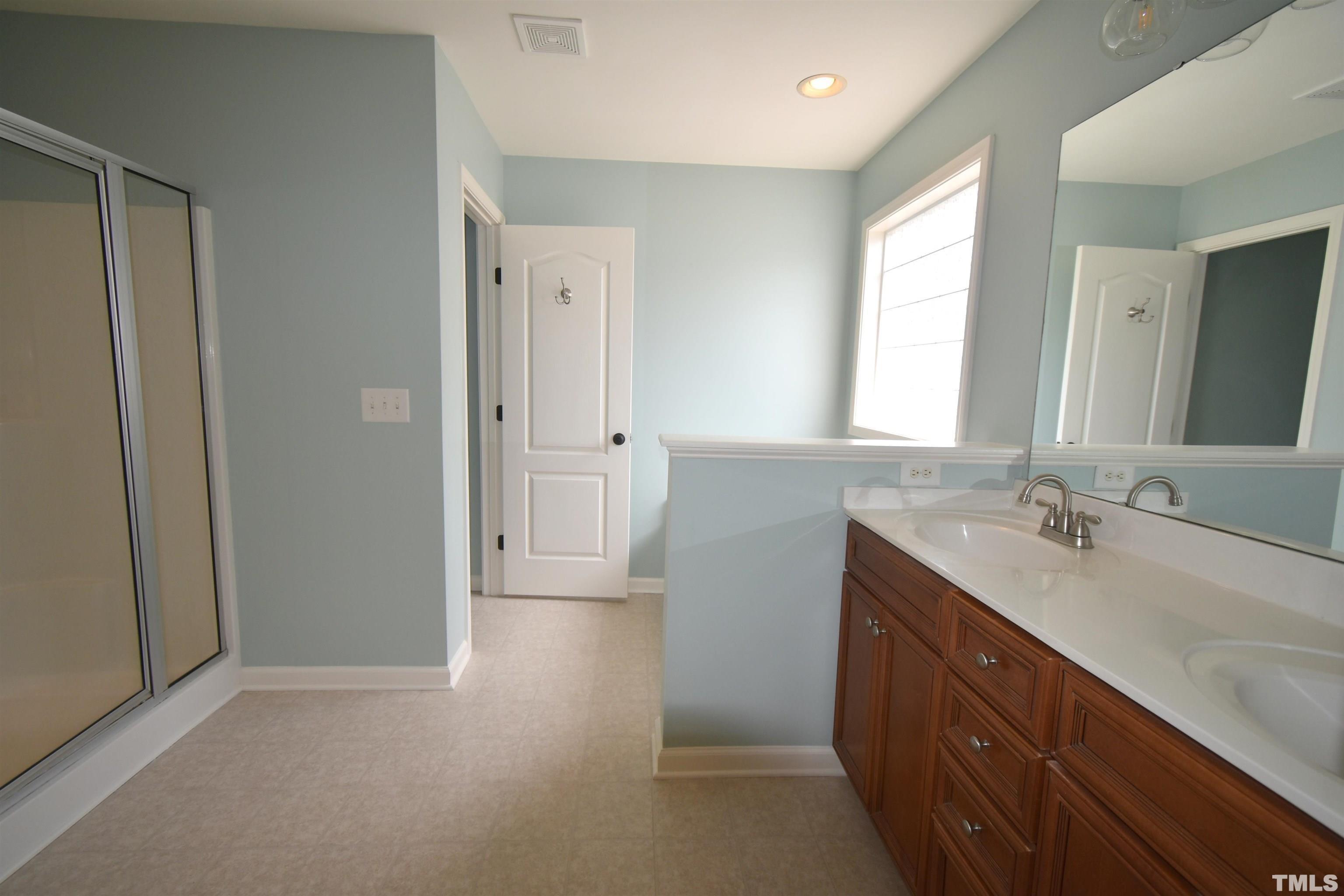 2019 Sinclair Trace Burlington, NC 27215 - Photo 21 of 32 a bathroom with a sink a mirror and a shower