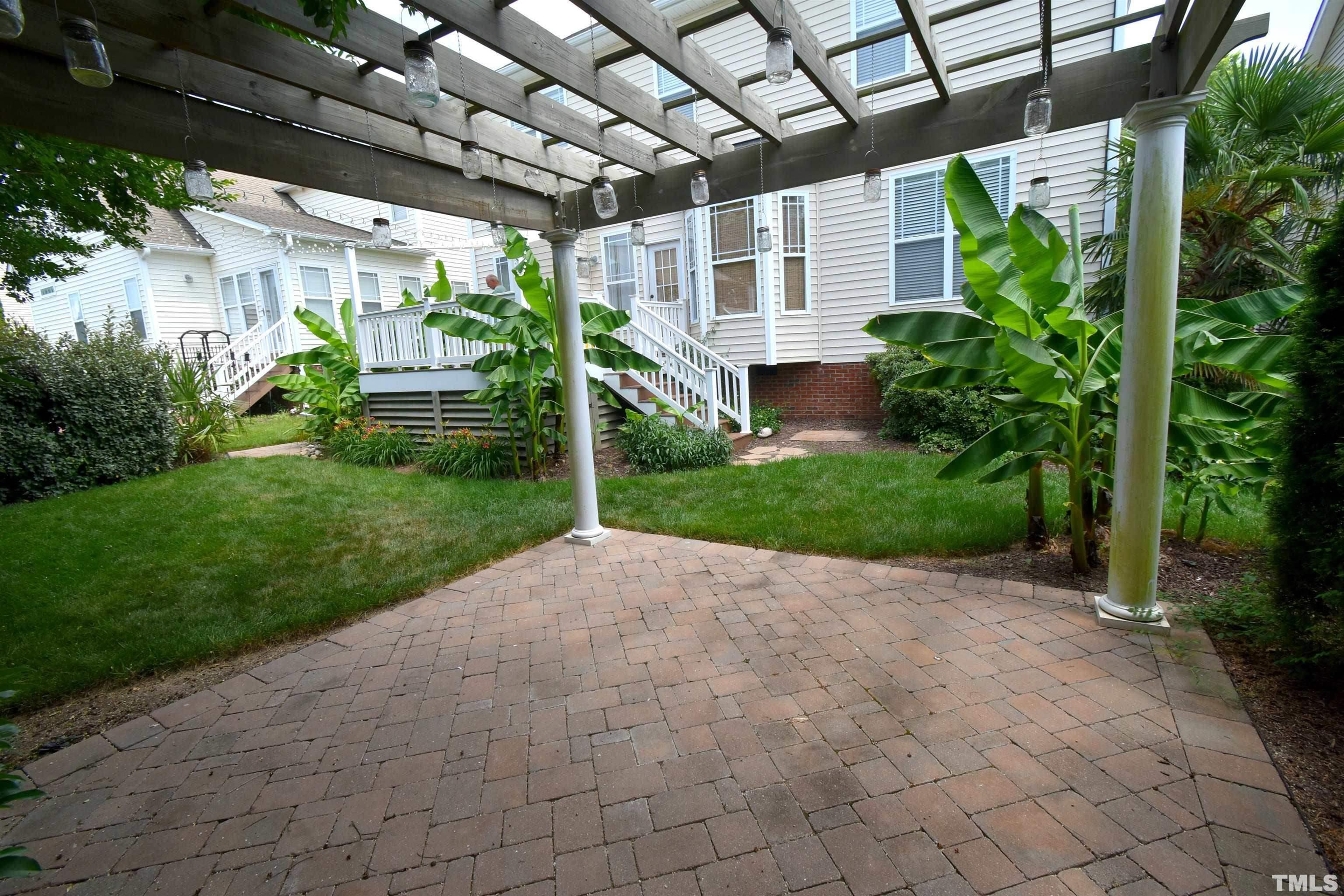 2019 Sinclair Trace Burlington, NC 27215 - Photo 26 of 32 a view of a house with a big yard and potted plants