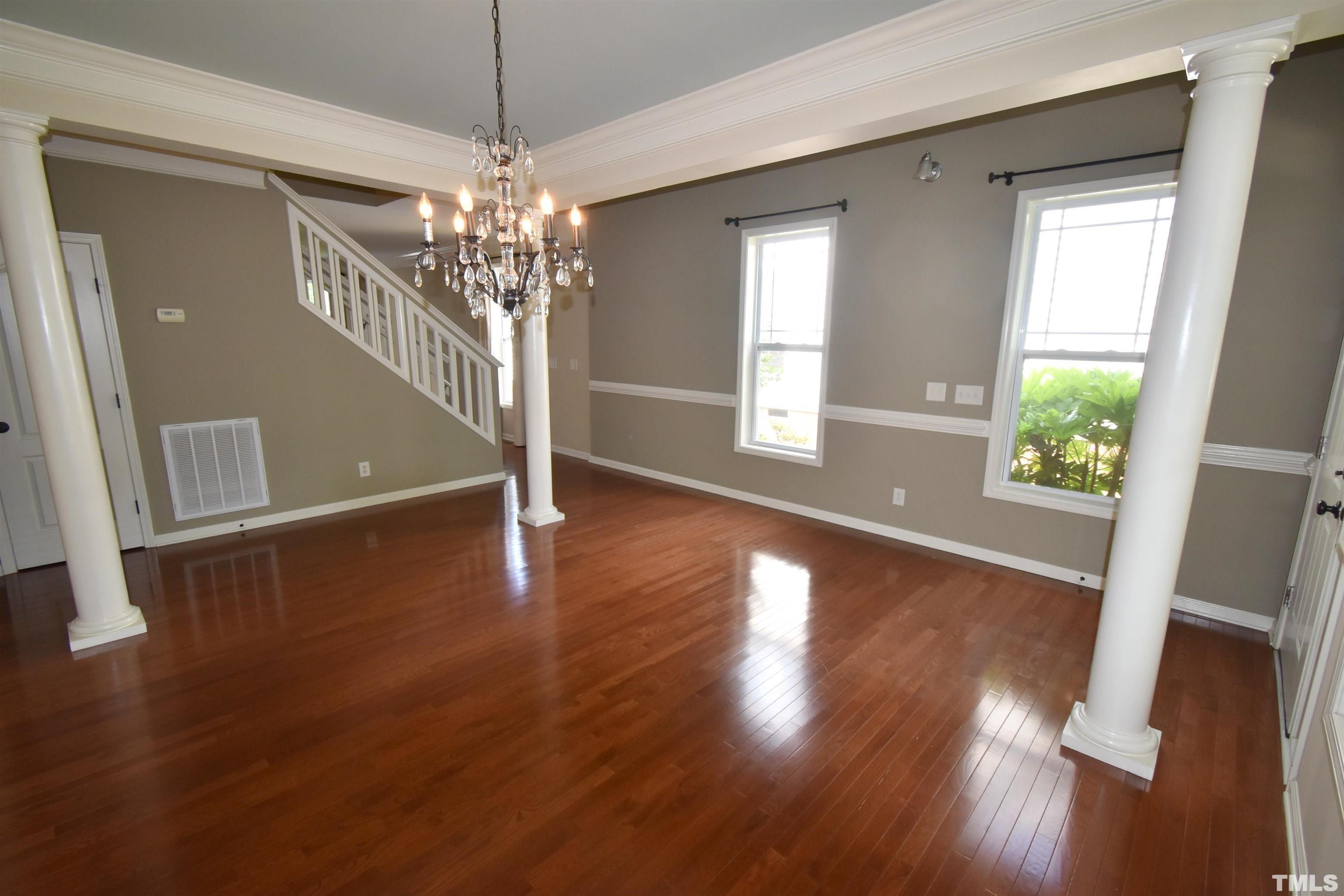 2019 Sinclair Trace Burlington, NC 27215 - Photo 6 of 32 a view of a livingroom with wooden floor and a chandelier