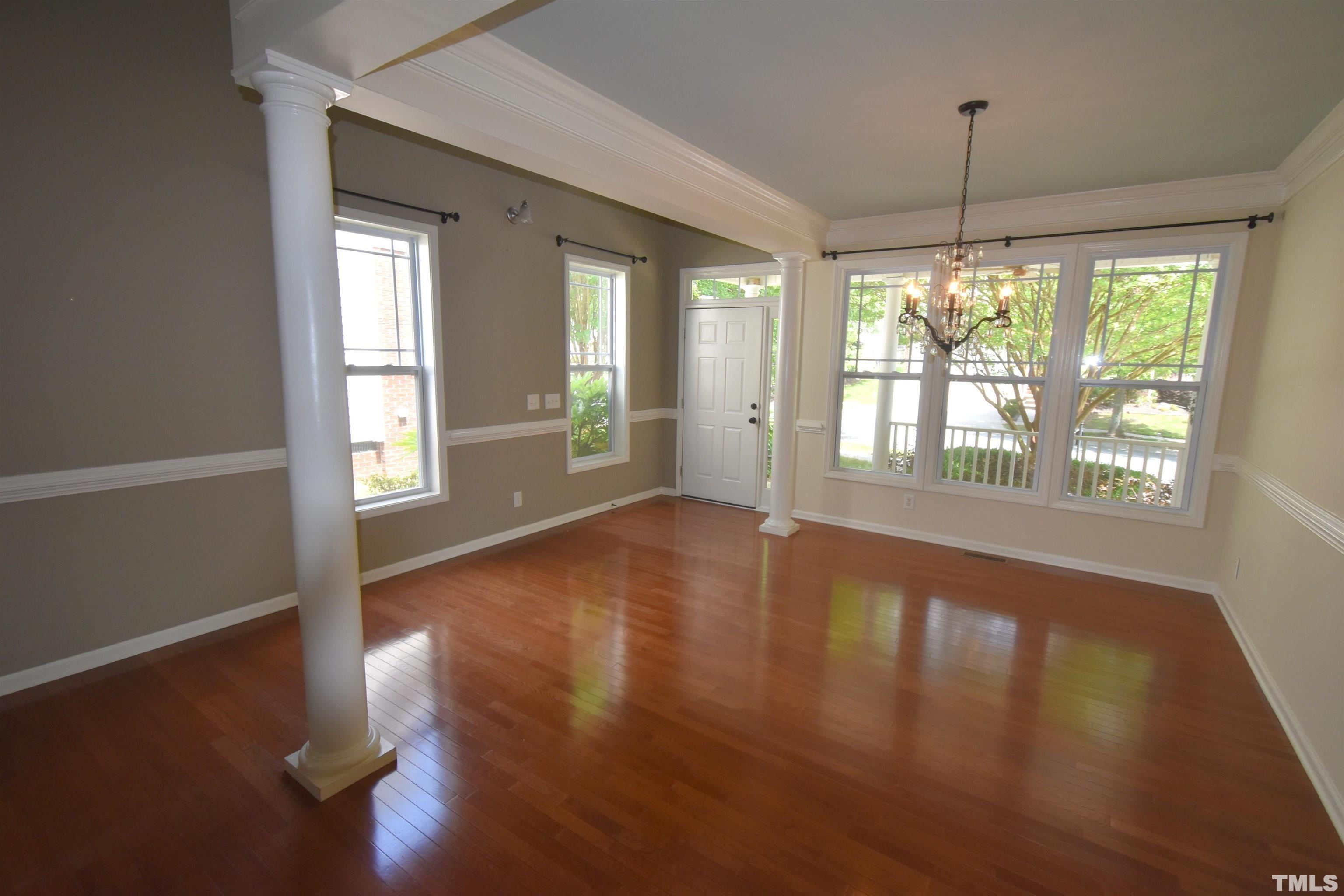 2019 Sinclair Trace Burlington, NC 27215 - Photo 8 of 32 a view of an empty room with wooden floor and a window