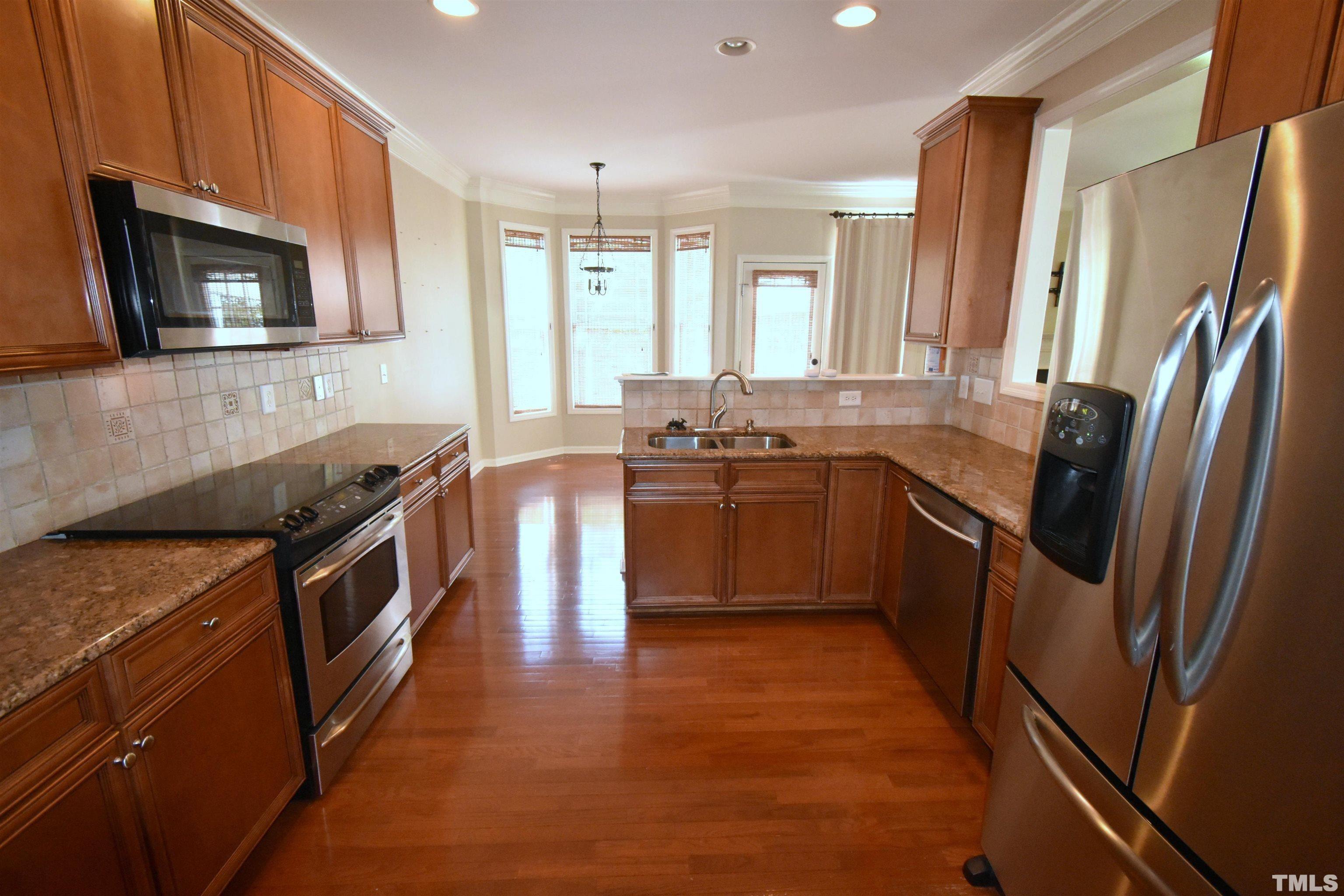 2019 Sinclair Trace Burlington, NC 27215 - Photo 10 of 32 a kitchen with stainless steel appliances granite countertop a stove a sink and a refrigerator