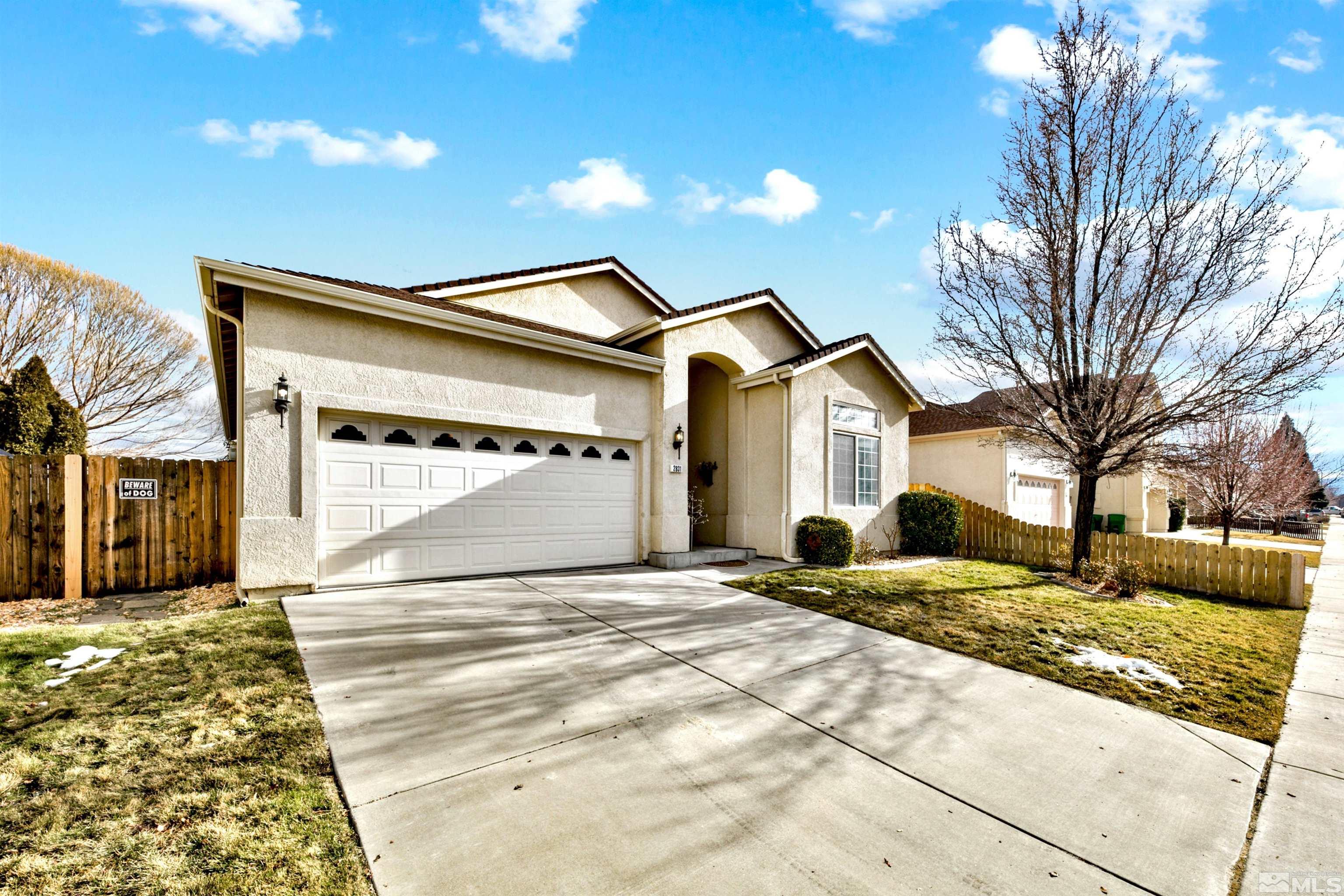 2831 Longridge Drive Carson City, NV 89706 - Photo 1 of 27 a view of a white house with a large trees