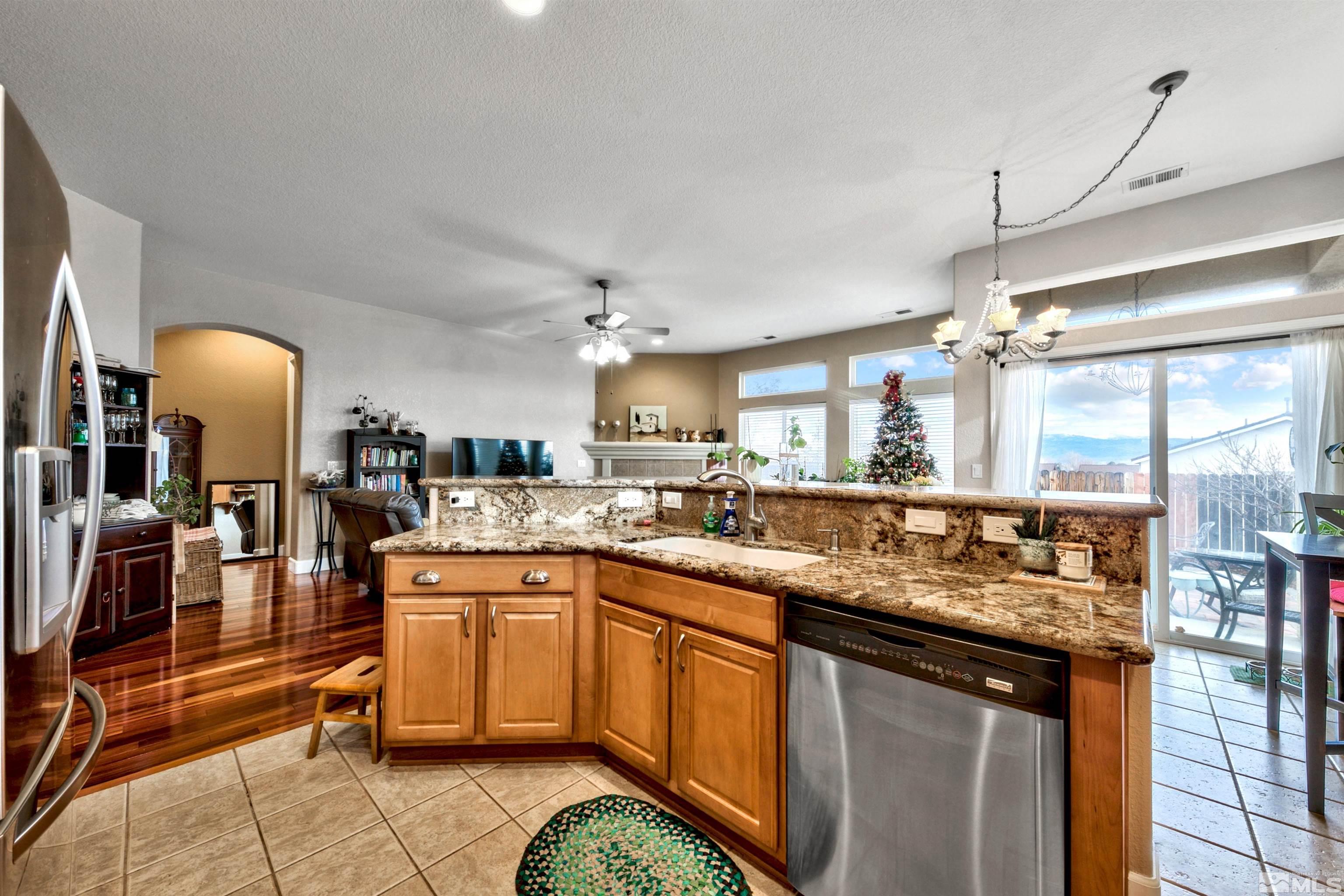 2831 Longridge Drive Carson City, NV 89706 - Photo 13 of 27 a kitchen with a sink counter top space and living room view