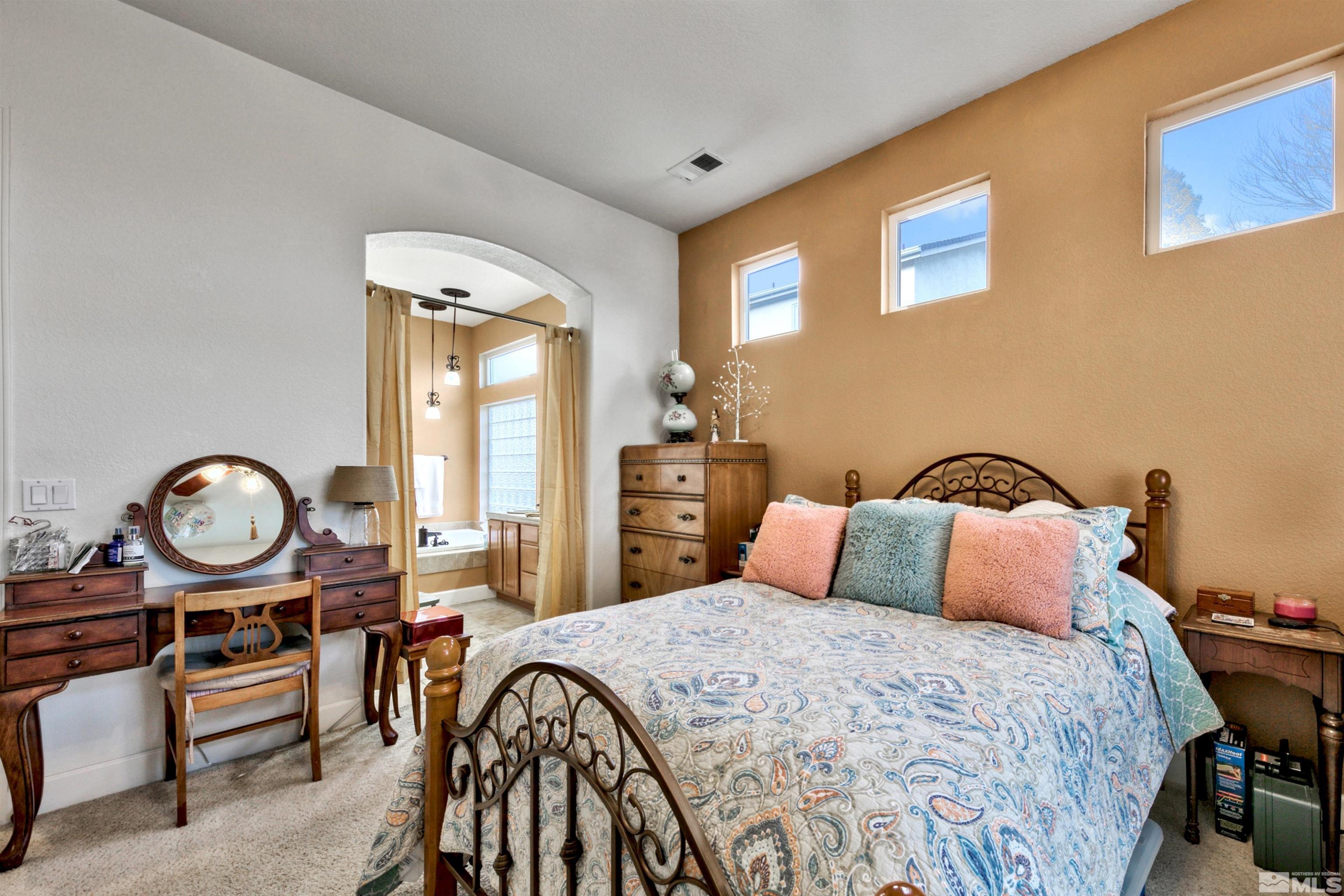 2831 Longridge Drive Carson City, NV 89706 - Photo 17 of 27 a bedroom with a bed and a chandelier