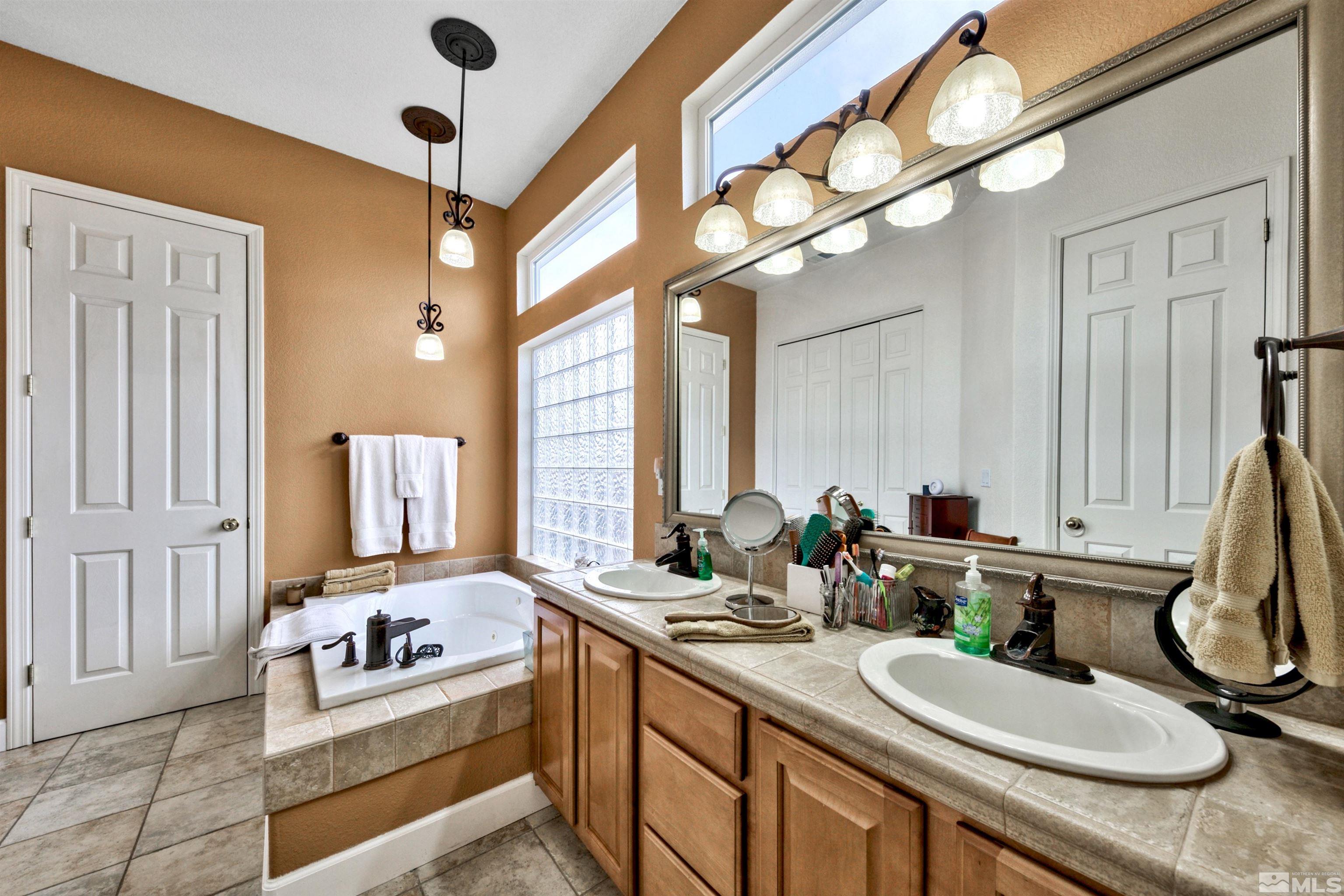 2831 Longridge Drive Carson City, NV 89706 - Photo 18 of 27 a bathroom with a sink double vanity granite and a mirror
