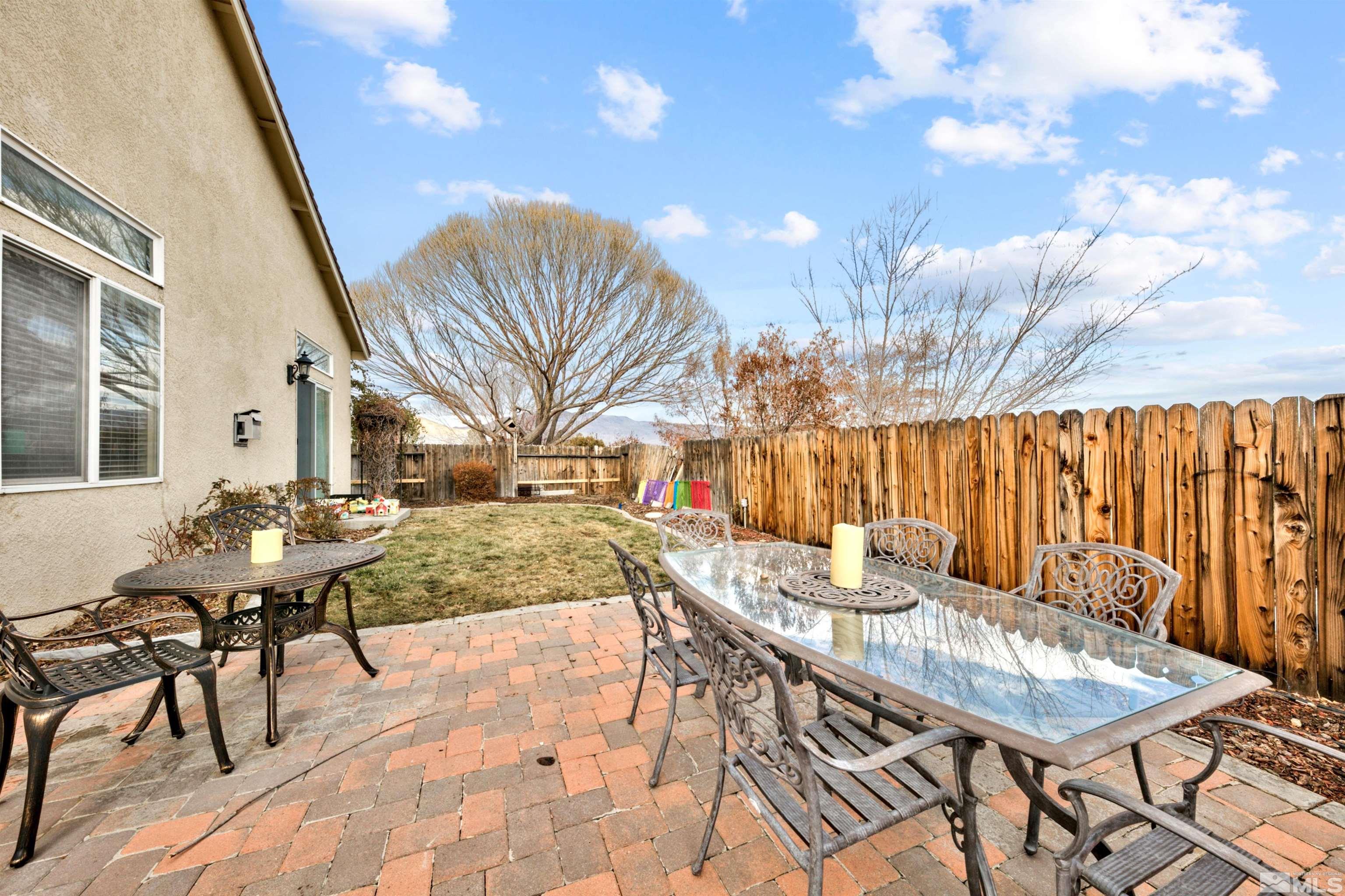 2831 Longridge Drive Carson City, NV 89706 - Photo 25 of 27 a view of a patio with table and chairs with wooden floor and fence
