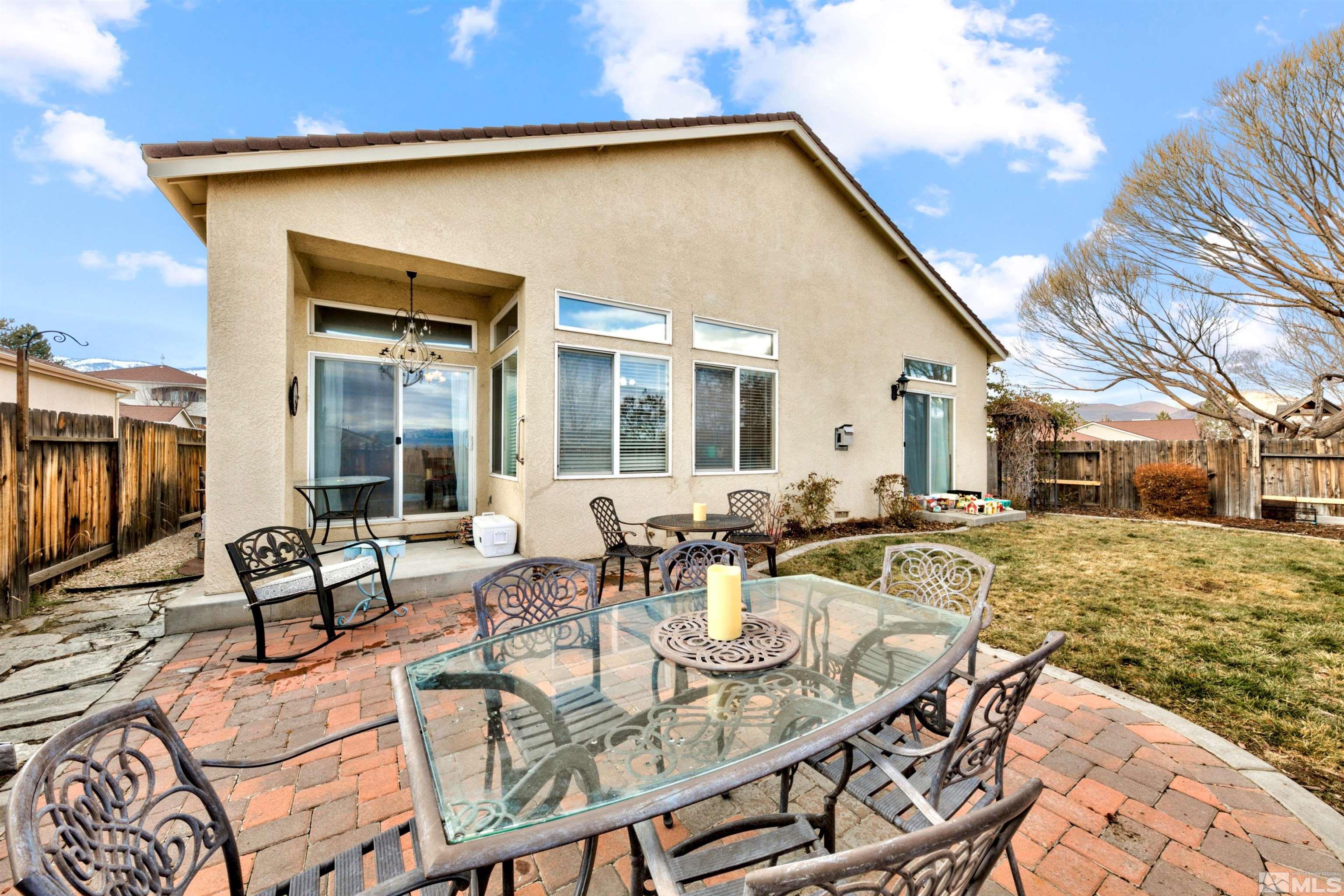 2831 Longridge Drive Carson City, NV 89706 - Photo 27 of 27 a view of a patio with table and chairs and floor to ceiling window