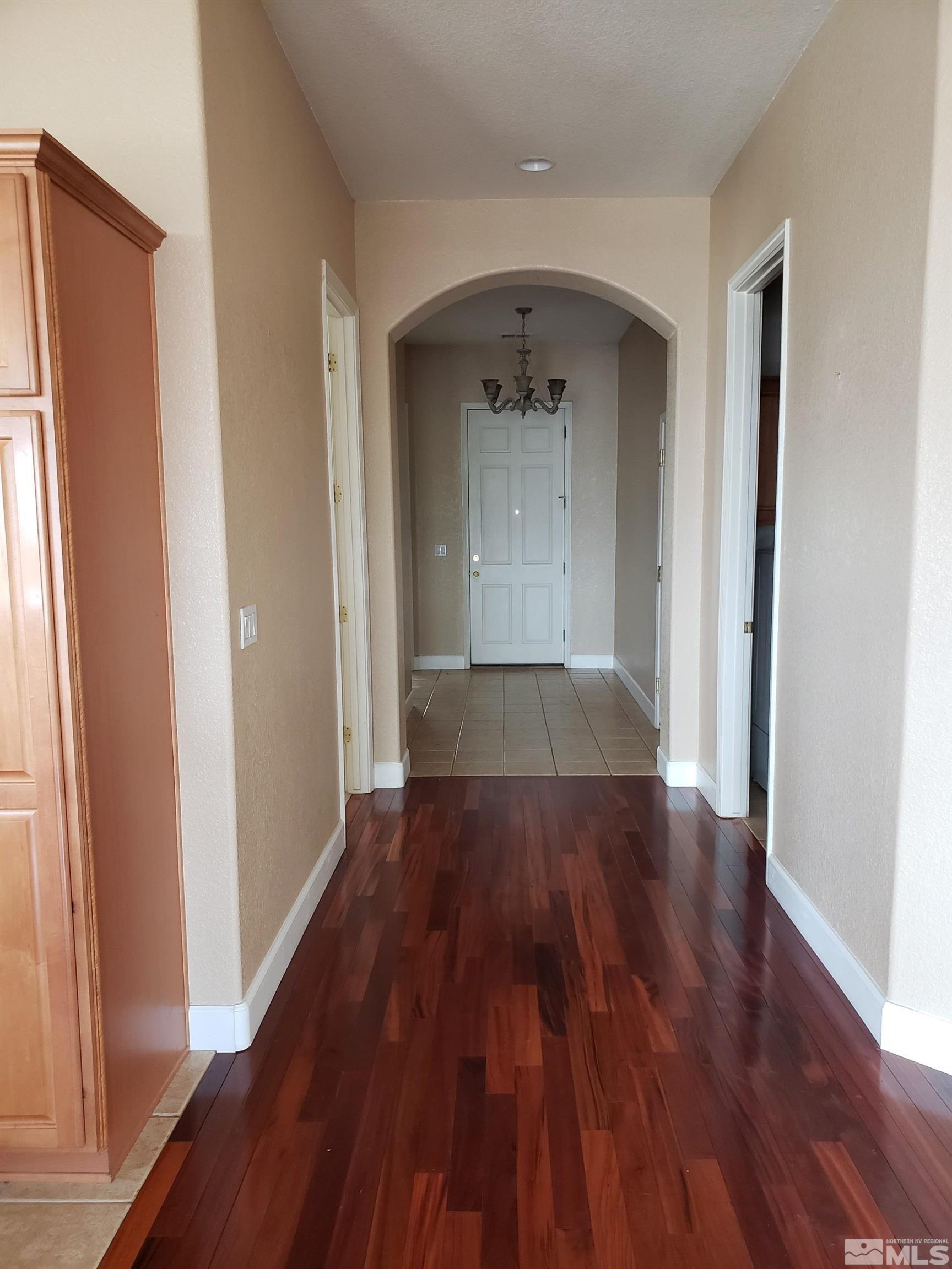 2831 Longridge Drive Carson City, NV 89706 - Photo 3 of 27 an empty room with wooden floor and a window